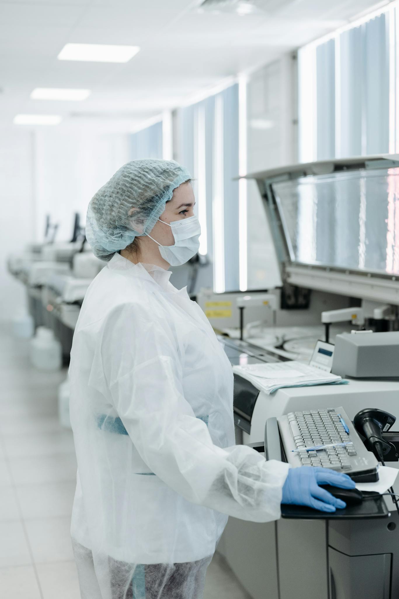 Scientist working with advanced equipment in a modern laboratory setting.
